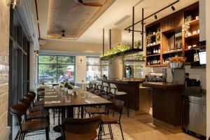 a restaurant with tables and chairs and a bar at VISION Omonia Athens in Athens +108 photos