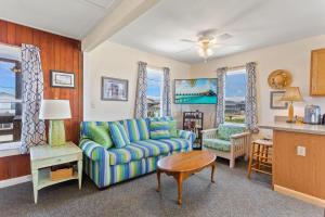 a living room with a couch and a table at 4020 - Gardners Hut in Kitty Hawk Beach