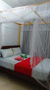 Postel nebo postele na pokoji v ubytování mirissa niraj guest