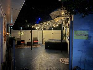 a patio at night with a bed and lights at Little Italy - Welcome to Rome in Jacksonville