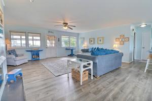 a living room with a blue couch and a table at 4140 - Beach Carousel in Kitty Hawk