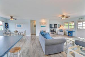 a living room with a couch and a table at 4140 - Beach Carousel in Kitty Hawk +35 photos