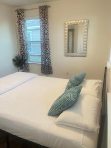 a bedroom with a bed with pillows and a mirror at Vees home away from home in Rosharon +43 photos