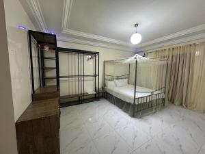 a bedroom with a bed with a canopy at Express at home in Dakar