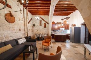 a living room with a couch and a kitchen at Villa To Palati with Private Pool Anogyra in Anoyira