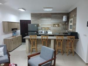a kitchen with a counter and some chairs and a counter top at Sea View 2 Bedroom Apartment in El-Hadaba in Hurghada