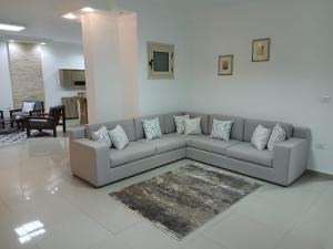 a living room with a gray couch and a rug at Sea View 2 Bedroom Apartment in El-Hadaba in Hurghada