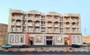 a large building with cars parked in front of it at Sea View 2 Bedroom Apartment in El-Hadaba in Hurghada