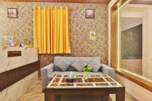 a living room with a couch and a table at Hotel Kasol Heritage in Lucknow +48 photos