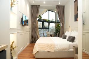 a bedroom with a large bed and a window at Moonlight Apartments Tirana in Tirana +61 photos