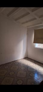 an empty room with a window and a tiled floor at Delsur in Neuquén