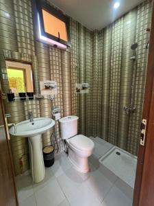 a bathroom with a toilet and a sink and a shower at Express at home in Dakar +24 photos