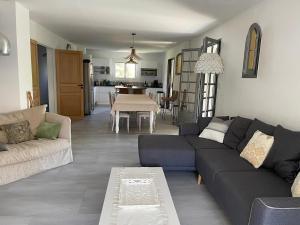 a living room with a couch and a table at L 'Évasion in Saint-Cyprien