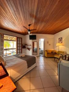 a bedroom with a large bed with a wooden ceiling at Pousada Recanto da Serra in Serra do Cipo +125 photos