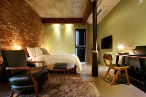a bedroom with a bed and a brick wall at Boutique Hotel Loft in Seoul