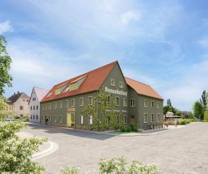 a large green building with a red roof at Ranunkelhof in Pirna