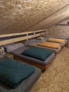 a group of beds sitting in a room at Le Nid in Abbaretz