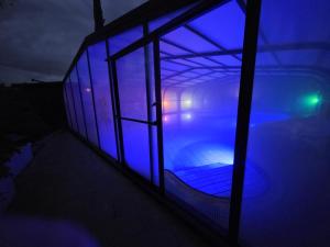 a building with a pool with blue lights on it at Arbel Guest House Shavit Family in Arbel