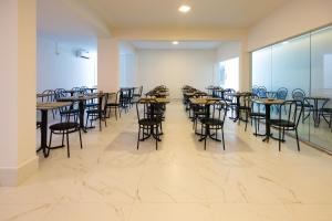 a row of tables and chairs in a room at Sirius Beach Hotel in Natal