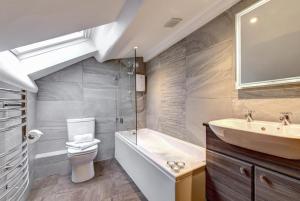 a bathroom with a sink and a toilet and a tub at 2 Bed in Elterwater oc-gl004 in Chapel Stile +4 photos
