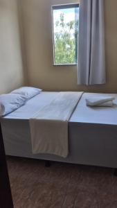 En eller flere senge i et værelse på Hotel João de Barro