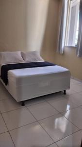 En eller flere senge i et værelse på Hotel João de Barro