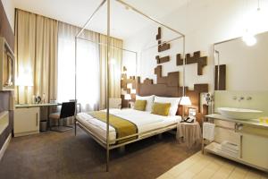 a bedroom with a canopy bed with a sink and a bathroom at Pure White in Prague +53 photos