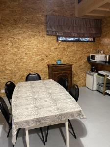a table and chairs in a room with a kitchen at Le Nid in Abbaretz