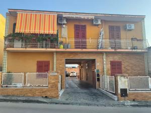 an apartment building with a balcony and a hallway at Free Parking - Maria House in Torre del Greco