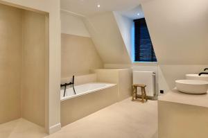 a bathroom with a sink and a bath tub at exceptional luxury villa near Knokke Golf in Knokke-Heist