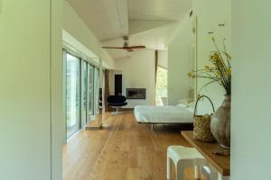 a bedroom with a bed and a table and a chair at La Forestale Luxury Ecolodge - La Suite Royale in Acqualagna