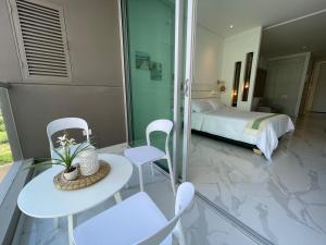 a bedroom with a bed and a table and chairs at Patty del Mar Suites in Santa Marta +40 photos