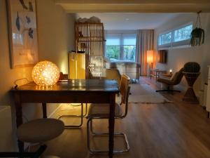 a living room with a wooden table and chairs at studio Le Garage in Bergen