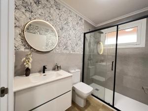 a bathroom with a toilet and a sink and a mirror at Ribeira Sacra Ledicia in Chantada +35 photos