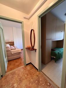 una camera con specchio e una camera con un letto di Casa Arcobaleno a Sanremo