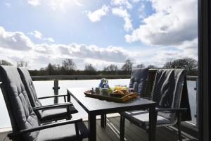 a table and two chairs on a deck with a view at Kirschgarten 17 in Kellenhusen