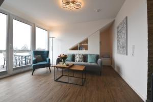 a living room with a couch and a table at Kirschgarten 17 in Kellenhusen
