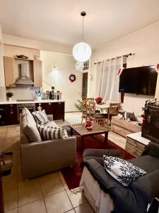 a living room with two couches and a table at Sissy sweet Home in Elátia
