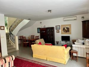 a living room with a couch and a table at Two bedroom villa with private swimming pool and garden in Almadies in Dakar