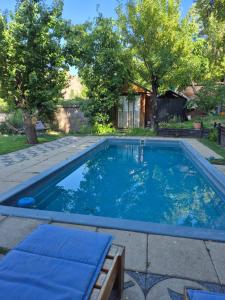 a swimming pool in a yard with trees at Carolin Cacao - Cabaña Nogal in San José de Maipo