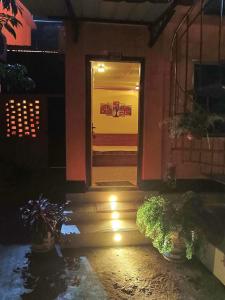 a door to a building with lights on the stairs at Green Zone Cottage 