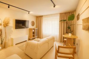 a living room with a couch and a table at Marabou Unique Stay in Thessaloniki