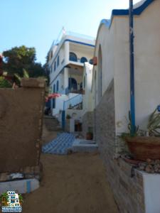 an alley with a white building and a building at Nubian Lotus in Aswan