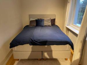 Kungsbacka Företagsbostad في كونغْسباكا: سرير مع لحاف أزرق في غرفة النوم