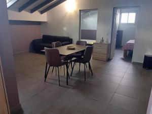a living room with a table and chairs and a couch at sci careffour dugomier in Le Moule