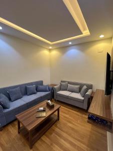a living room with two couches and a coffee table at شقق العرين للشقق المخدومة in Jeddah +9 photos