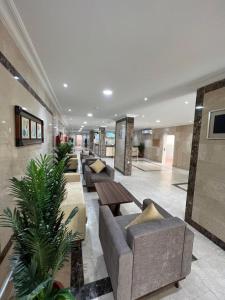 a lobby with couches and tables in a building at شقق العرين للشقق المخدومة in Jeddah