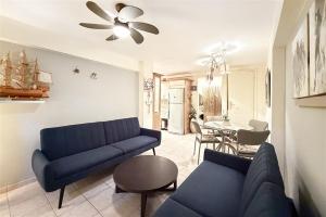 a living room with a blue couch and a table at Nerida House Salonikiou Beach in Akti Salonikiou