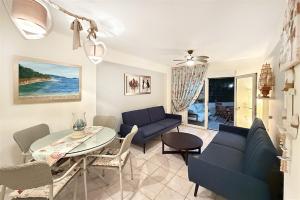 a living room with a blue couch and a table at Nerida House Salonikiou Beach in Akti Salonikiou +33 photos