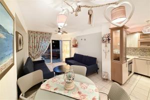 a living room with a table and a kitchen at Nerida House Salonikiou Beach in Akti Salonikiou